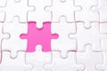 White jigsaw puzzle with with one piece missing and pink background Royalty Free Stock Photo