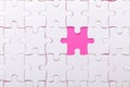 White jigsaw puzzle with with one piece missing and pink background Royalty Free Stock Photo