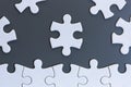 White jigsaw puzzle pieces on gray background Royalty Free Stock Photo