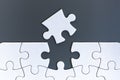 White jigsaw puzzle pieces on gray background Royalty Free Stock Photo