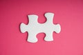 White jigsaw puzzle pieces on pink background. Royalty Free Stock Photo