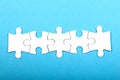 white jigsaw puzzle pieces row on blue background Royalty Free Stock Photo