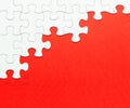 White jigsaw puzzle on red background Royalty Free Stock Photo