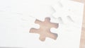 white jigsaw puzzle is showing missing piece on wooden tabletop, flat design for business strategy Royalty Free Stock Photo