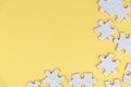 White jigsaw puzzle with some missing pieces on soft yellow background. Blank missing puzzle piece for your creative text idea. Royalty Free Stock Photo