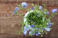 White jug with bouquet of meadow flowers on wooden background Royalty Free Stock Photo