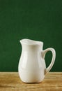 White jug on old wooden table