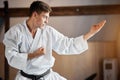 Karate Fighter practises fight in martial arts gym