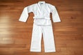 a white karate gi uniform on a wooden dojo floor