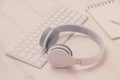 White keyboard of computer on table with headphone. View from above Royalty Free Stock Photo