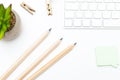 White keyboard with pencils and succulent on white background. F Royalty Free Stock Photo