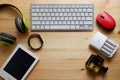 White keyboard with wireless mouse and bluetooth wireless headphones and other electronic gadgets for daily use on wooden Royalty Free Stock Photo