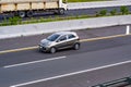 White Kia picanto driving fast on the trans jawa highway blurry in motion Royalty Free Stock Photo