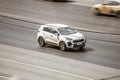 White Kia Sportage SUV car moving on city street. Front side aerial view of compact crossover on highway background Royalty Free Stock Photo