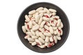 white kidney beans in black bowl isolated on white background. top view