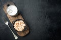 White kidney beans, with metal can, in bowl, on black stone background, top view flat lay, with copy space for text Royalty Free Stock Photo