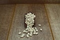 White kidney beans in wooden scoop isolated on wooden background close up. Top view. Royalty Free Stock Photo