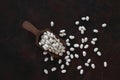 White kidney beans in wooden scoop isolated on wooden background close up. Top view. Royalty Free Stock Photo