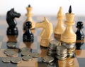 White king and other chess with coins on chess board Royalty Free Stock Photo