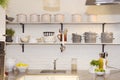 White Kitchen, Colorful Fruits on Granite Counter, Pots and Plates on Shelves