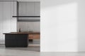 White kitchen interior with black island and blank wall Royalty Free Stock Photo