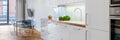 White kitchen open to dining area, panorama Royalty Free Stock Photo