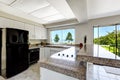 White kitchen room with black appliances and granite tops Royalty Free Stock Photo