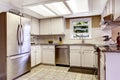 White kitchen room with steel appliances and tile backsplash trim Royalty Free Stock Photo