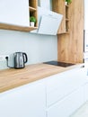 White kitchen Scandinavian interior with cooker hood on wooden countertop Royalty Free Stock Photo