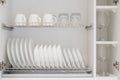 White kitchen storage cabinet with clean dishes Royalty Free Stock Photo