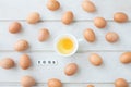 white kitchen table texture background with fresh yellow yolk egg on white cup and eggs text letter. Royalty Free Stock Photo
