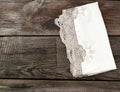 White kitchen textile lace towel folded on a gray wooden table from old boards Royalty Free Stock Photo