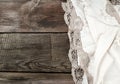 White kitchen textile lace towel folded on a gray wooden table from old boards Royalty Free Stock Photo