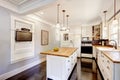 White kitchen with wooden counter top island and TV Royalty Free Stock Photo