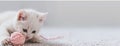 a white kitten as it plays gleefully with a pink ball of yarn against a soft pastel background, ensuring high-quality