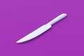 White knife on violet background