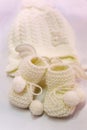 White knitted baby booties and hat Royalty Free Stock Photo