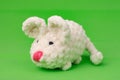 White knitted mouse, made with its own hands, on a green background Royalty Free Stock Photo