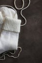 White knitted natural wool socks on a beige and gray table.