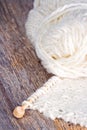 White knitting on rustic wooden background