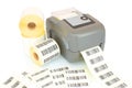 White label rolls, printed barcodes and printer isolated on white background with shadow reflection.