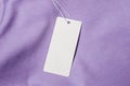 White Label and Tag on lilac cotton fabric. mockup Royalty Free Stock Photo