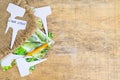 White labels-markers for plants lie on burlap, on wooden background.