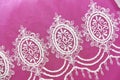 White lace fabric with floral ornament on pink background Royalty Free Stock Photo