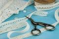 White lace ribbons on blue wooden background.
