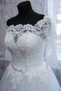 White lace wedding dress on a mannequin. Top part. Details of the bride`s attire at a wedding ceremony. Royalty Free Stock Photo