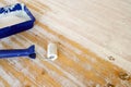 White lacquer in a blue paint tray and roller to renew the coating on an old table, furniture renovation and craft concept, copy Royalty Free Stock Photo