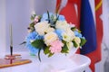 White lacquered table in the registry office on which there is a beautiful festive wedding bouquet of different flowers Royalty Free Stock Photo