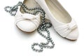White ladies shoes with silver pearl necklace