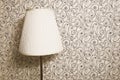 White lamp on the background of Wallpaper with a linear pattern. interior of the house, wall. background for the design.
